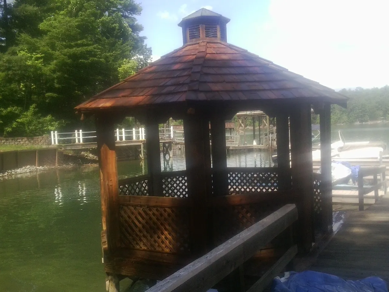 Cedar shake gazebo roof rebuilt on a lake dock in Newbury